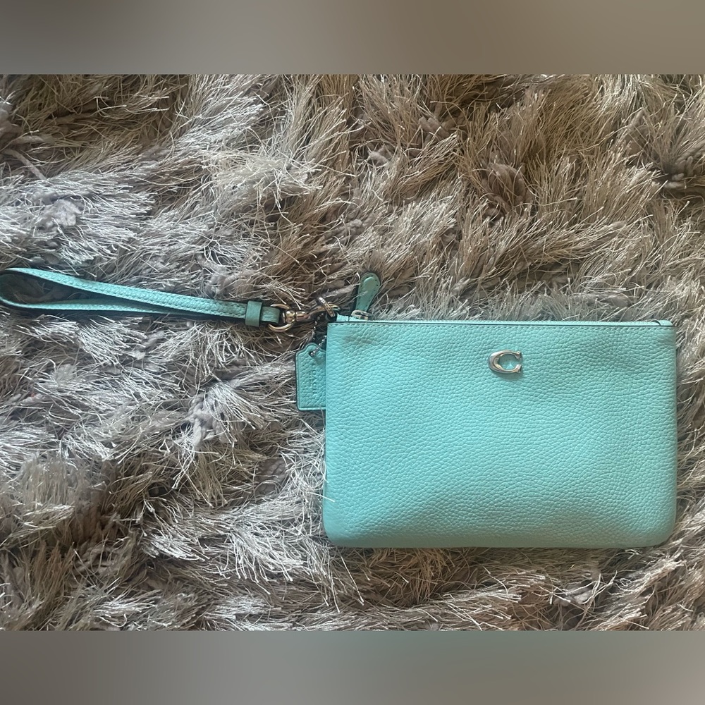 COACH pebbled leather small wristlet in faded blue.